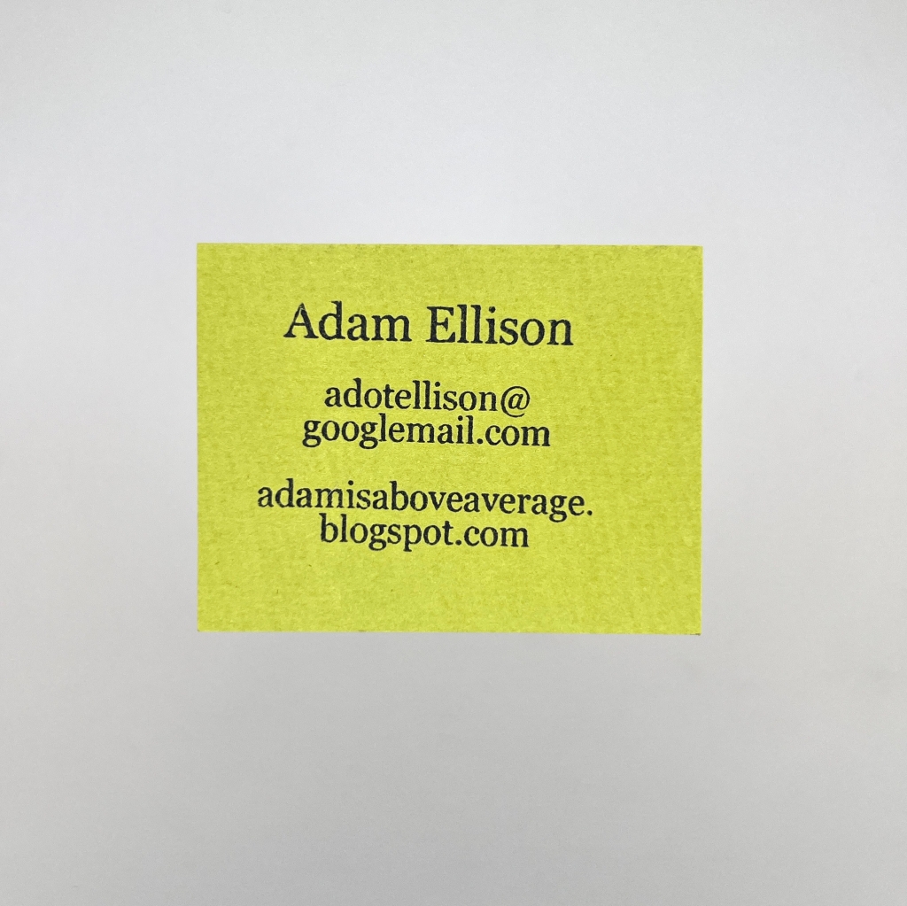 A green business card with old details for Adam Ellison.