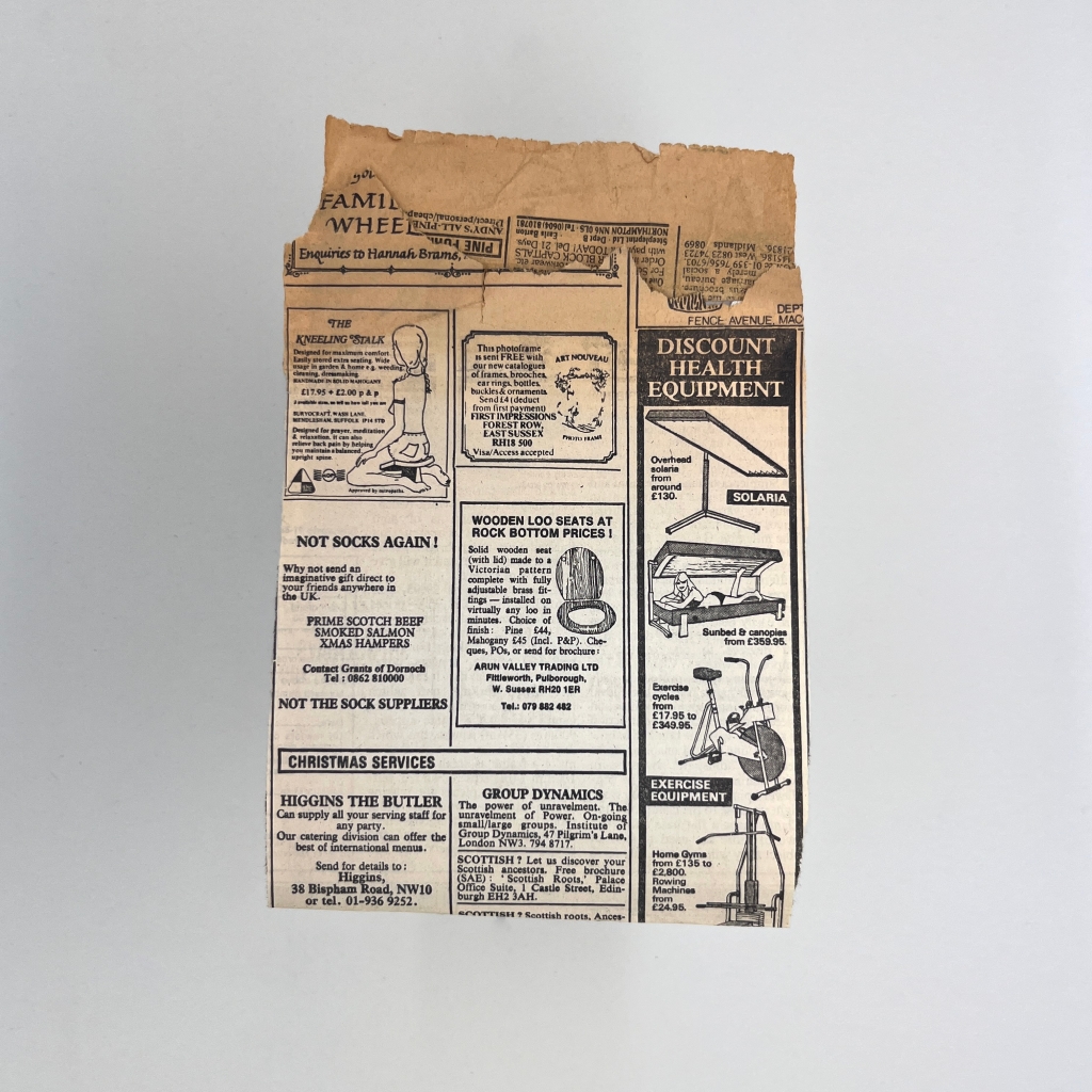 1 of 4 sides of and old piece of folded yellowing newspaper with classified adverts with illustrations of sun beds, an exercise bike and a home gym, loo seat, and someone sitting on a very tiny stool.