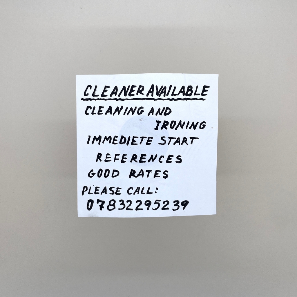 Small square piece of paper with capital letter handwriting saying Cleaner available cleaning and ironing immediate start references good rates please call 07832295239