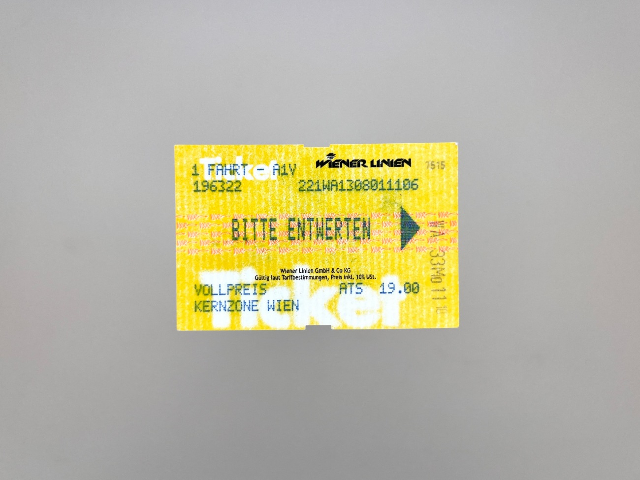 Another yellow ticket with green and black writing and white and pink graphic details overlayed and interrupting each other.