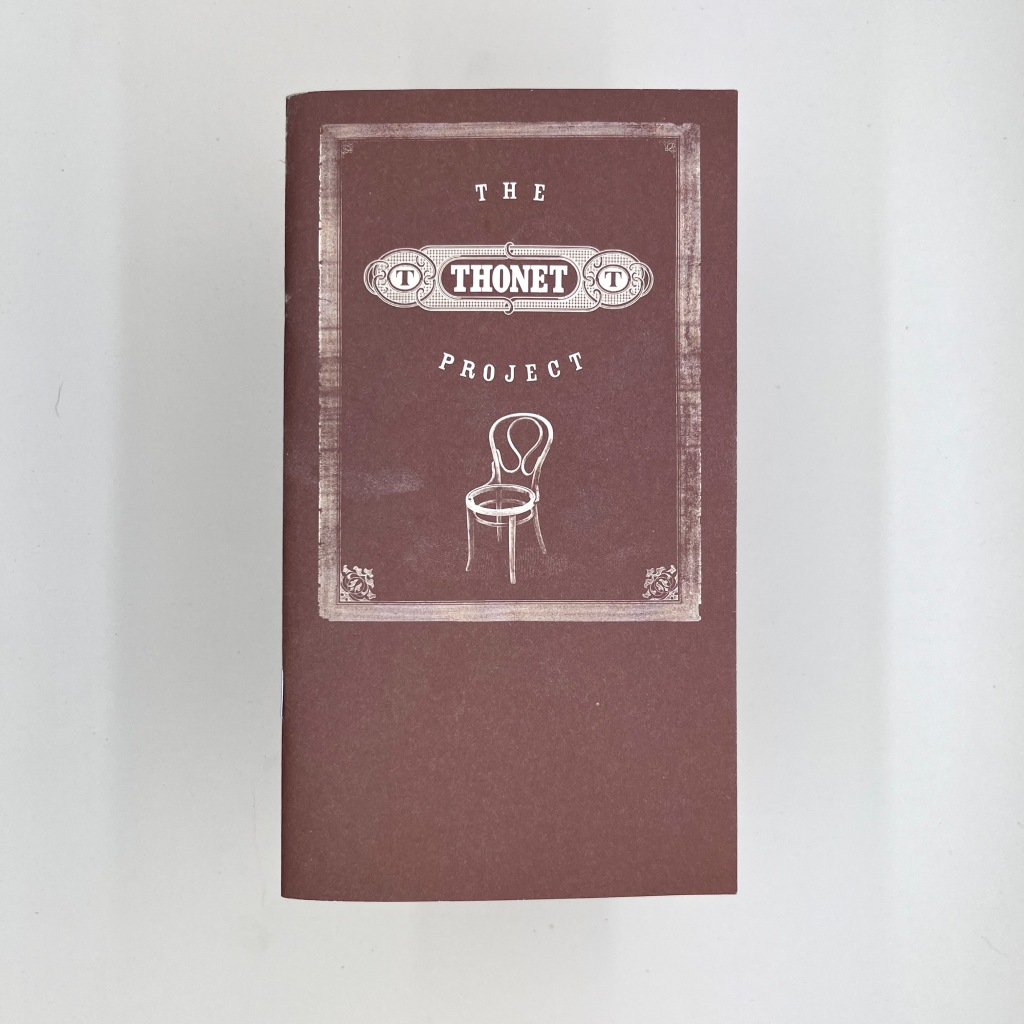 Front cover a The Thonet Project pamphlet with a photo of the classic bent wood chair. 