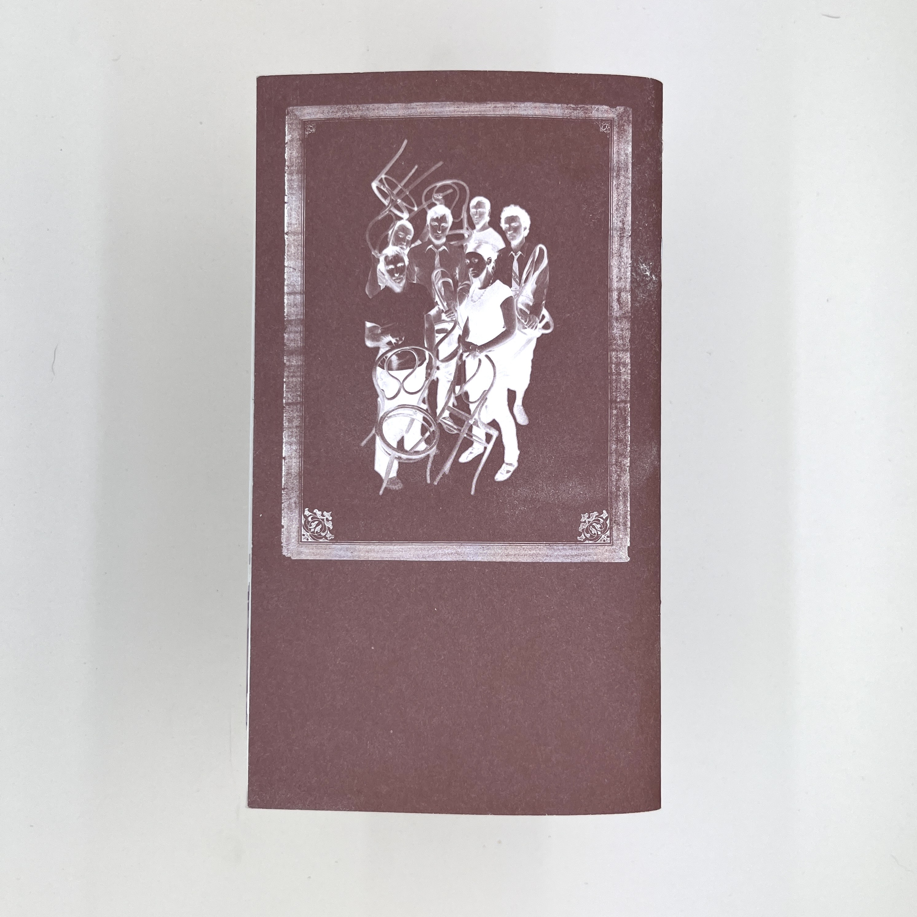 The back of the pamphlet showing a negative reversed image of a group of people